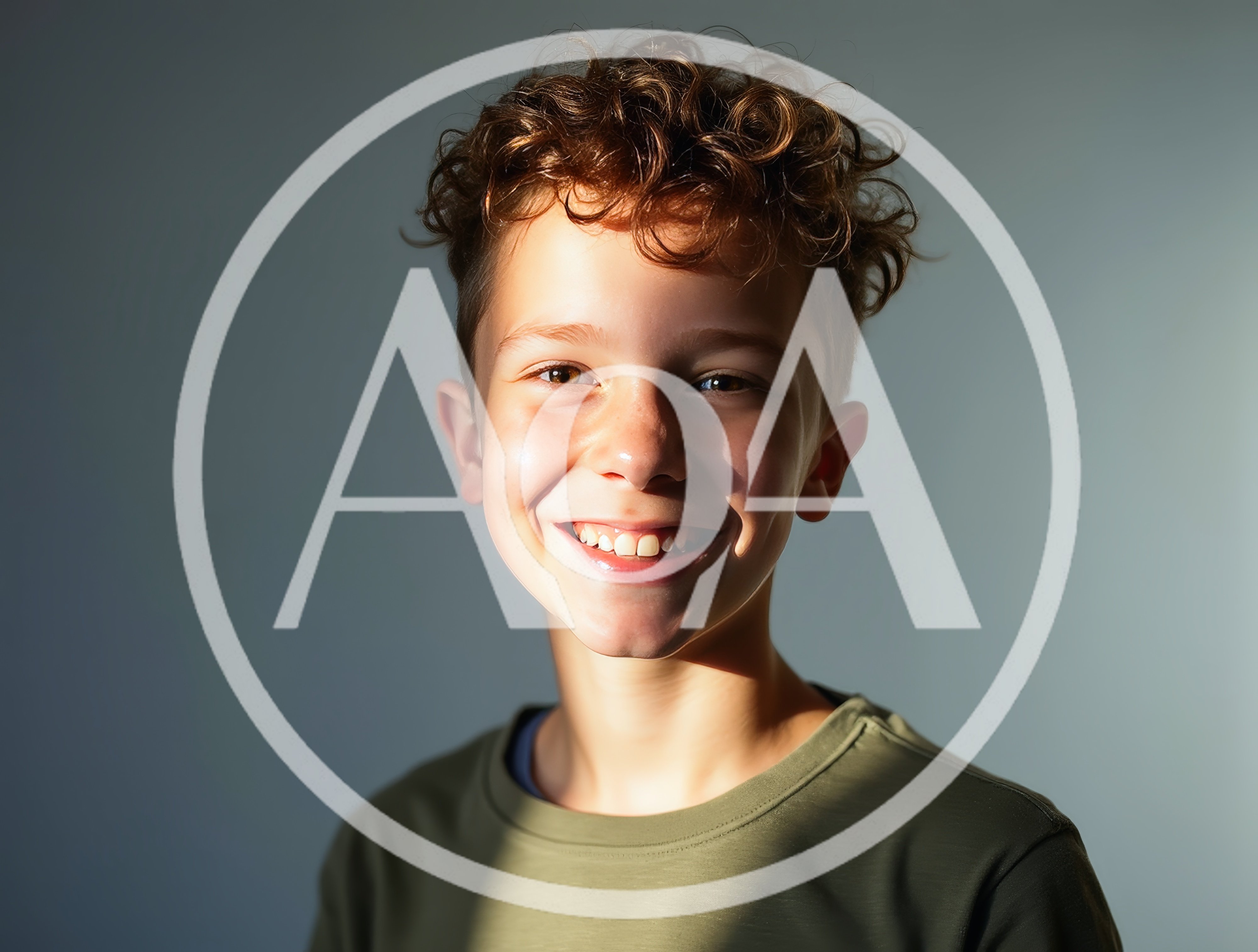 Portrait Of A Smiling Young Boy With Curly Hair