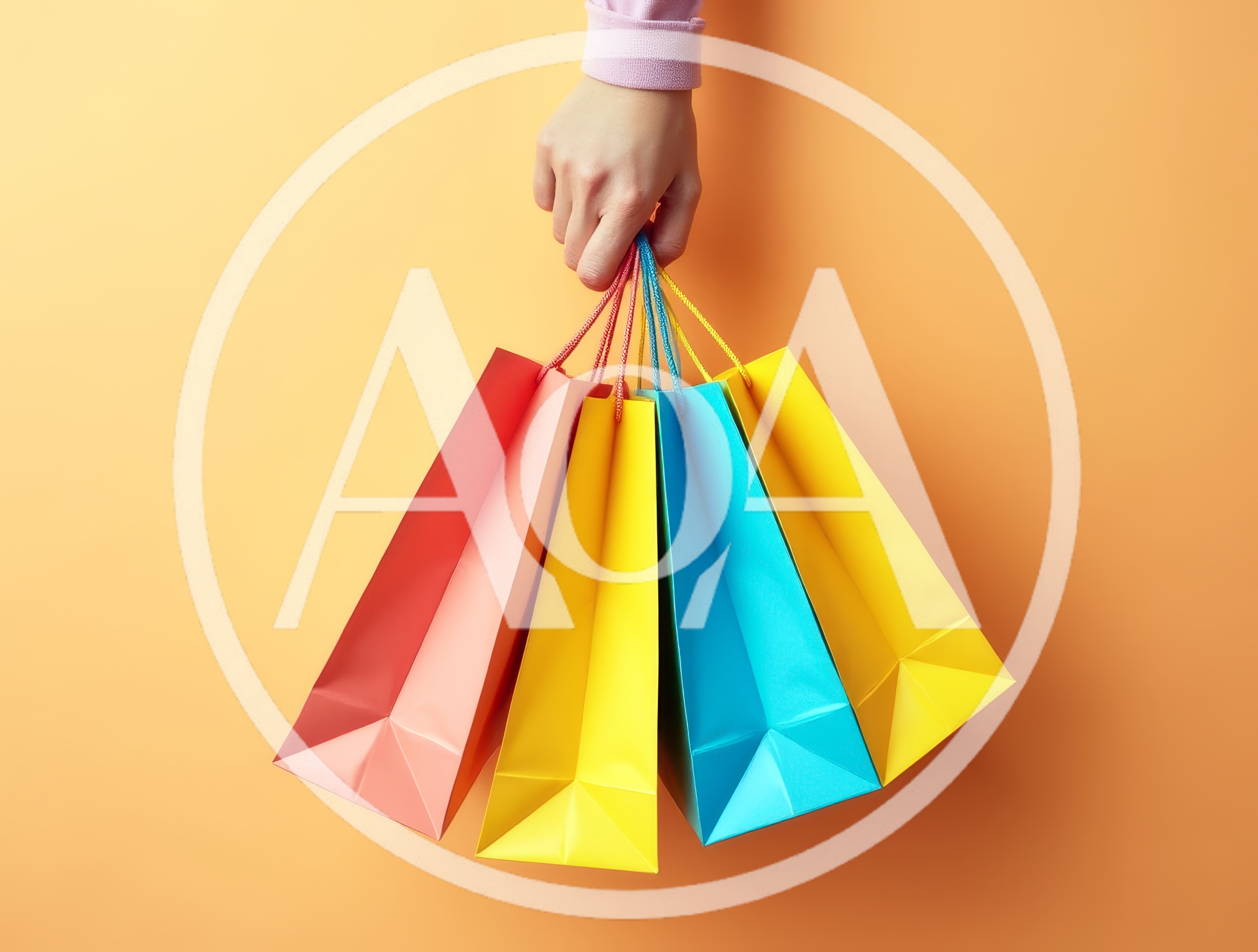 Hand Holding Colorful Shopping Bags Against Orange Background