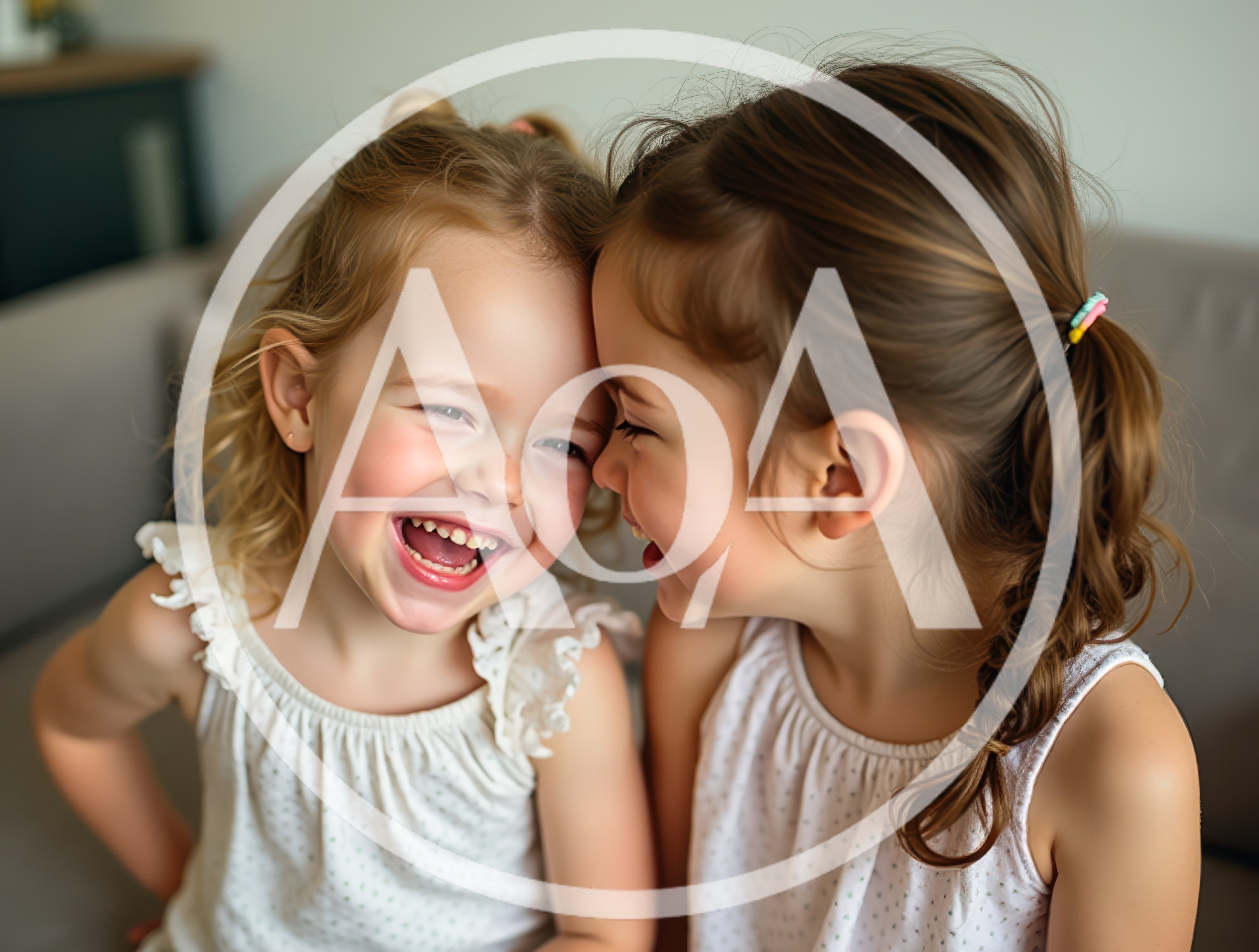 Two Young Girls Laughing Together Indoors