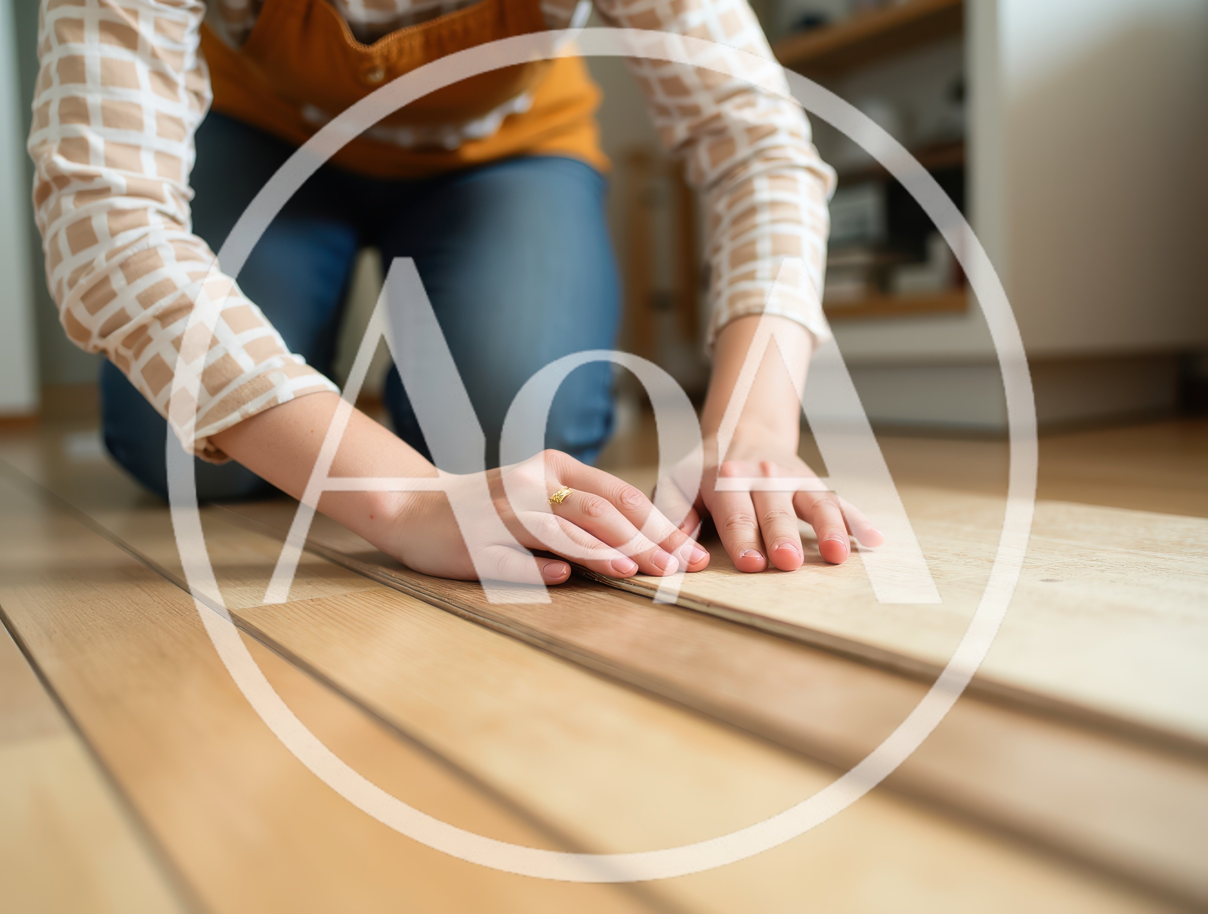 Person Installing Laminate Flooring In A Home