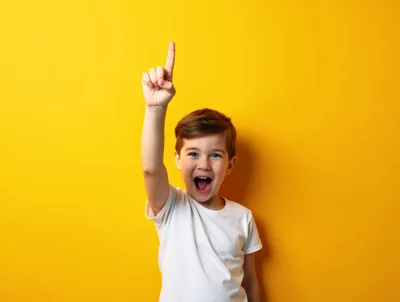 Excited Young Boy Pointing Upwards