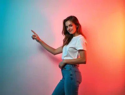 Young Woman Pointing To The Side In Studio