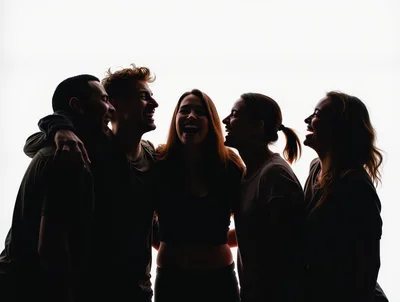 Group Of Friends Laughing Together In Silhouette