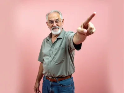 Senior Man Pointing Forward Against Pink Background