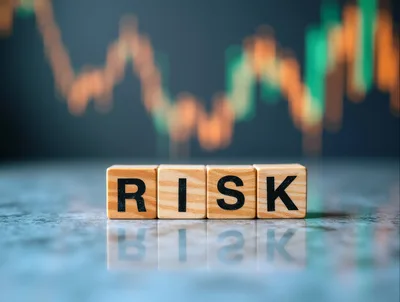 Wooden Blocks Spelling Risk With Financial Market Chart Background