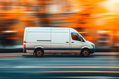 White Delivery Van Driving Fast On City Street