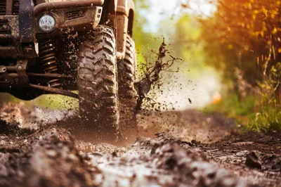 Off-Road ATV Driving Through Muddy Terrain