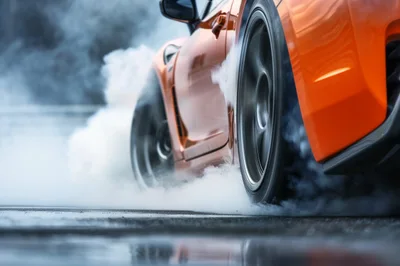 Orange Sports Car Performing A High Speed Drift