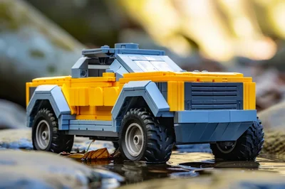 Yellow And Grey Toy Truck In Shallow Stream