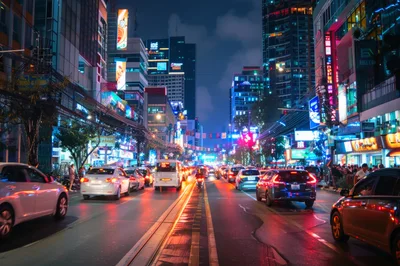 Busy Night Traffic On Illuminated City Street
