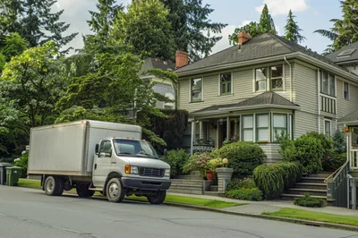 Moving Truck Parked In Front Of A Residential House