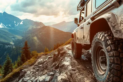 Off-Road Vehicle Driving On Rugged Mountain Trail