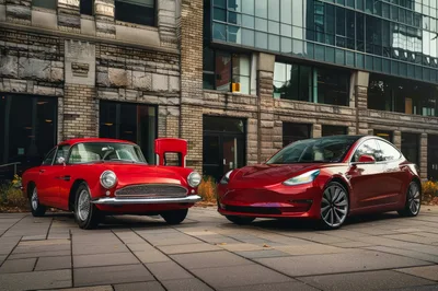 Classic And Modern Red Cars Parked On City Plaza