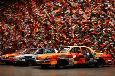 Three Vintage Cars Covered In Knitted Fabric
