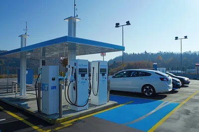 Electric Vehicle Charging Station At A Sunny Parking Lot