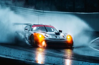 Racing Car Drifting Through Rain On Track