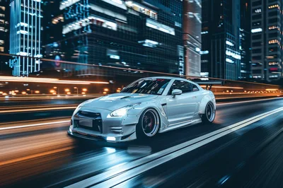 Modified White Nissan GT-R Driving Through City at Night