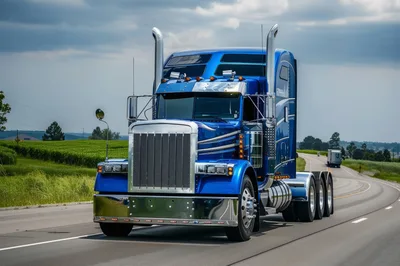 Blue Semi Truck Driving On Rural Highway