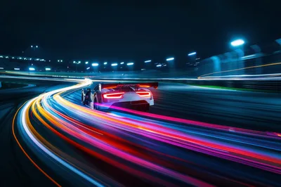 Racing Car Speeding on Track at Night