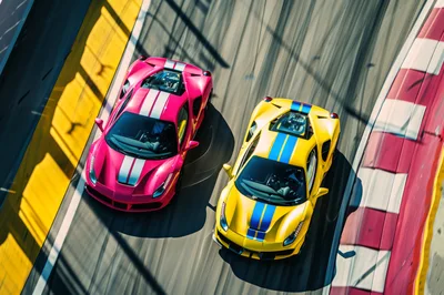 Pink and Yellow Supercars Racing on Track
