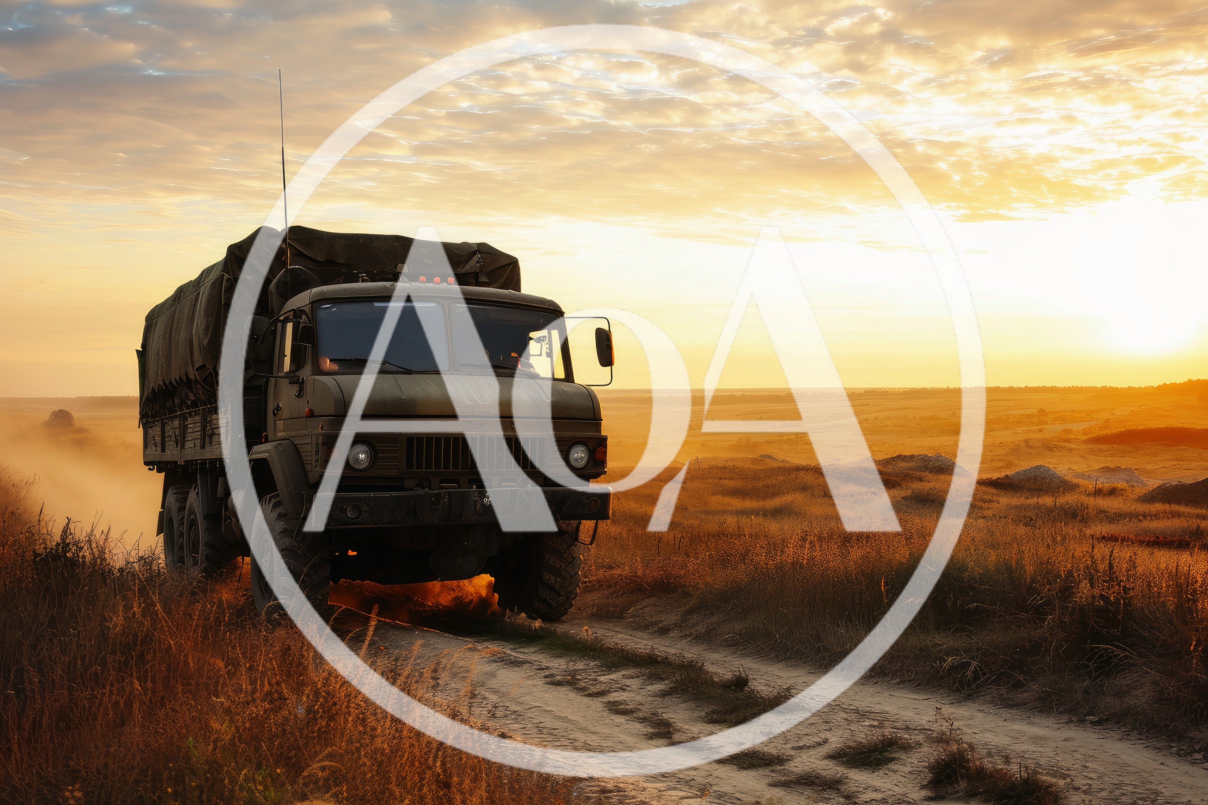 Military Cargo Truck Driving Through Dusty Field At Sunset