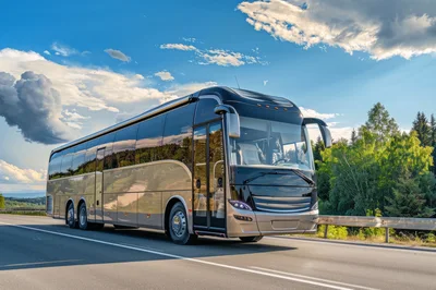 Modern Luxury Coach Bus Driving On A Scenic Highway