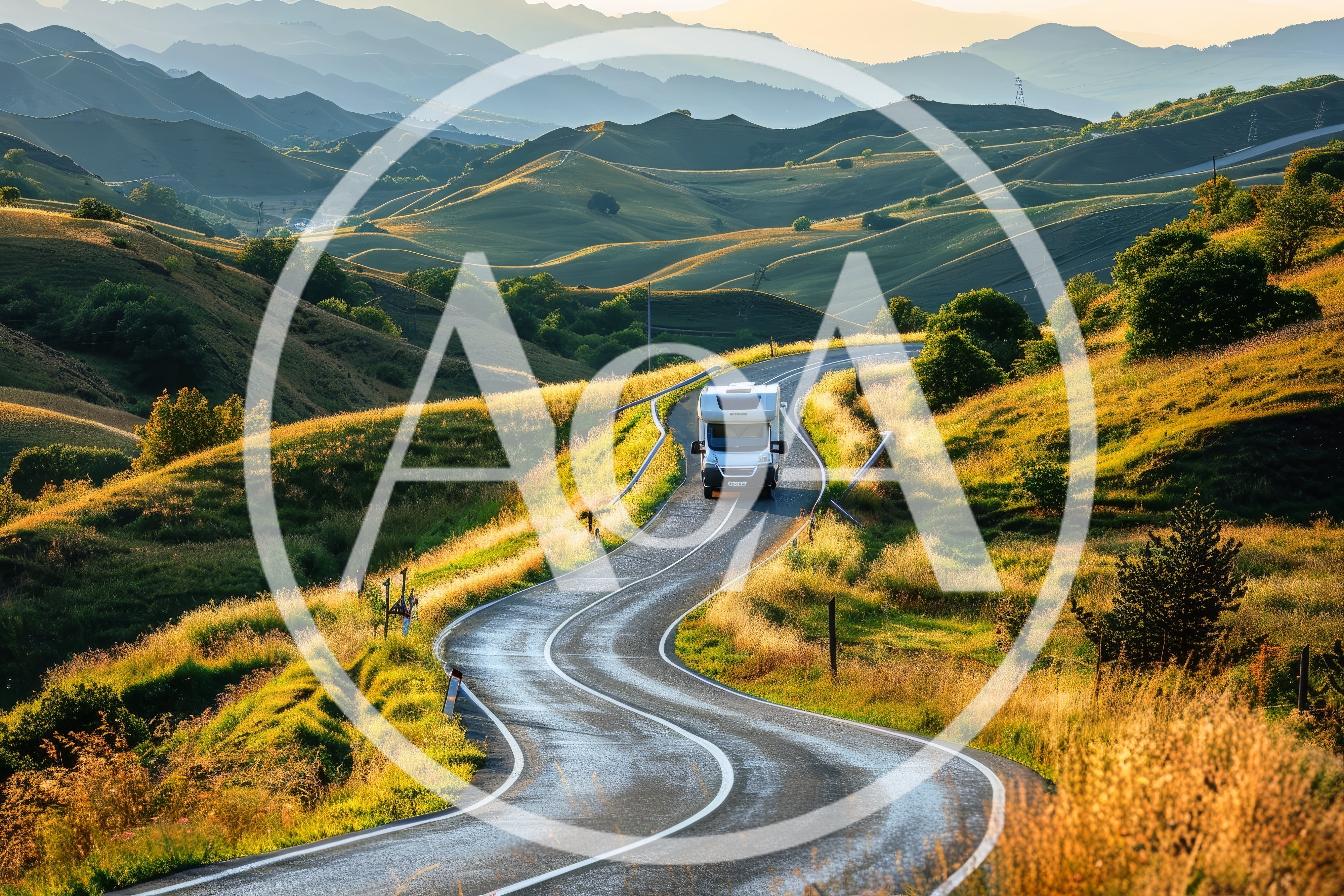 White Camper Van Driving Along A Winding Mountain Road