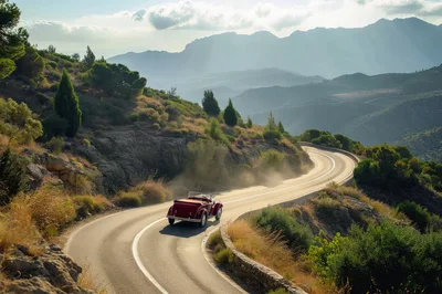 Vintage Red Convertible Driving On Winding Mountain Road