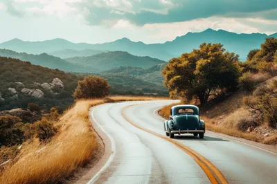 Vintage Car Driving Along A Winding Mountain Road