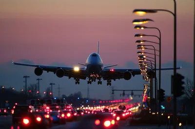 Large Passenger Airplane Landing Over Busy Highway Traffic