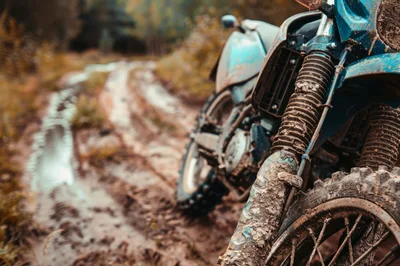 Muddy Dirt Bike Parked On A Forest Trail