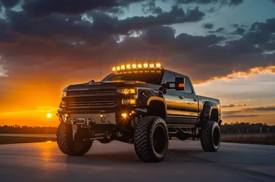 Custom Lifted Black Pickup Truck At Sunset
