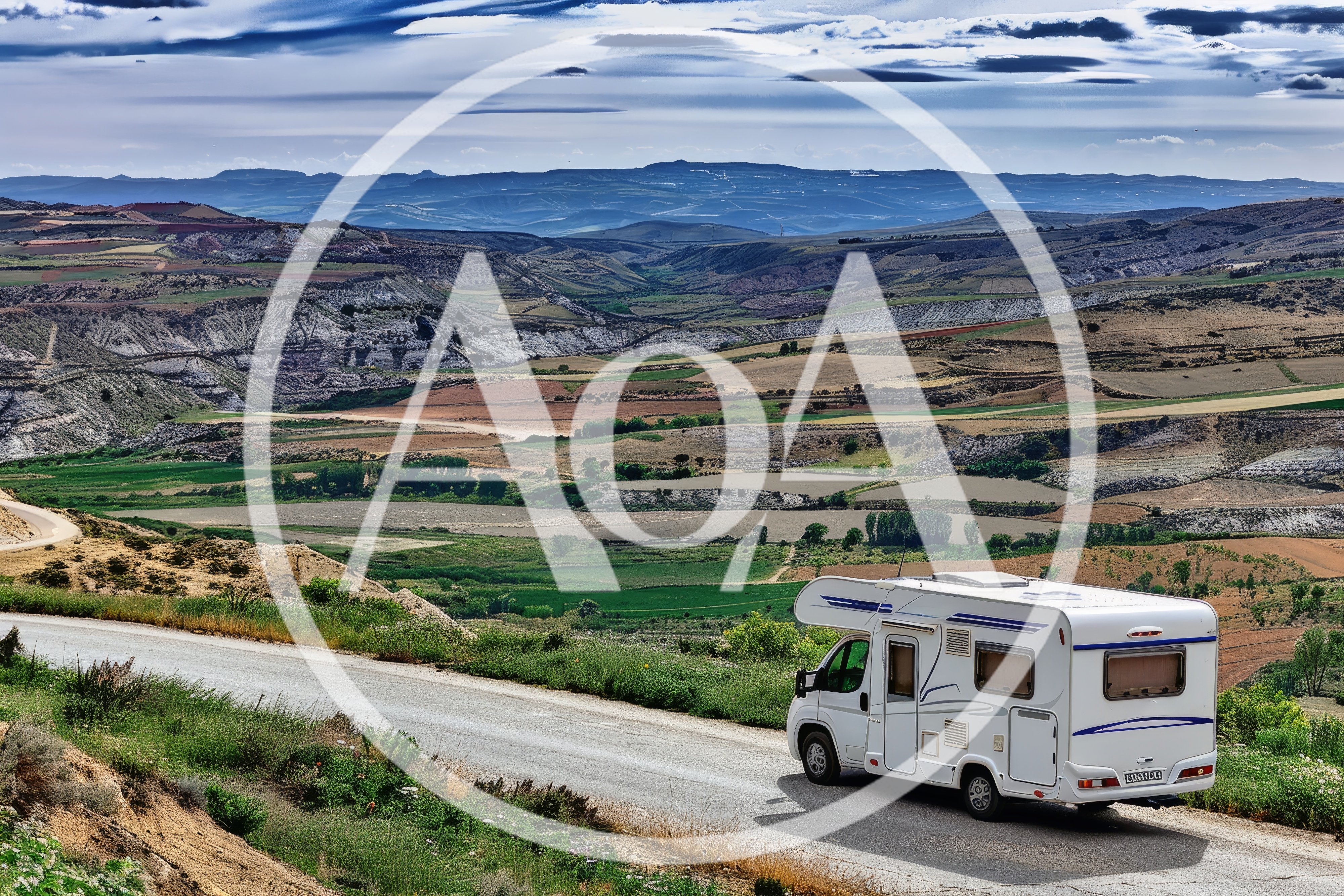 White Camper Van Driving Along A Scenic Mountain Road