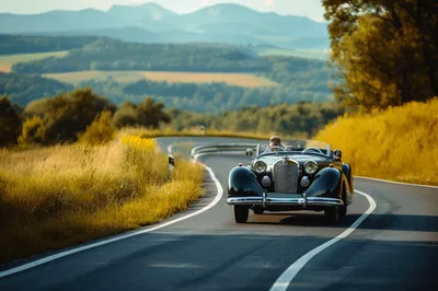 Vintage Convertible Driving Along A Scenic Mountain Road