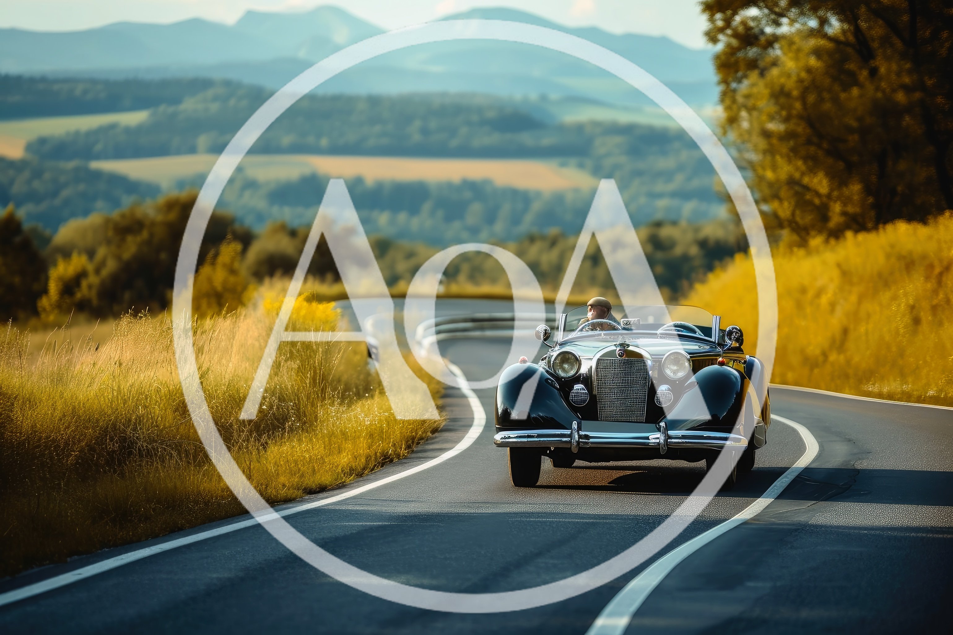 Vintage Convertible Driving Along A Scenic Mountain Road