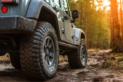 Off-Road Jeep Driving Through Muddy Forest Trail