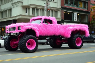 Pink Furry Monster Truck Driving On City Street