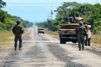 Military Soldiers Standing Guard on Rural Road