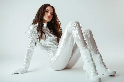 Fashion Model In Futuristic White Vinyl Bodysuit