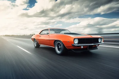 Orange Classic Muscle Car Driving On Highway