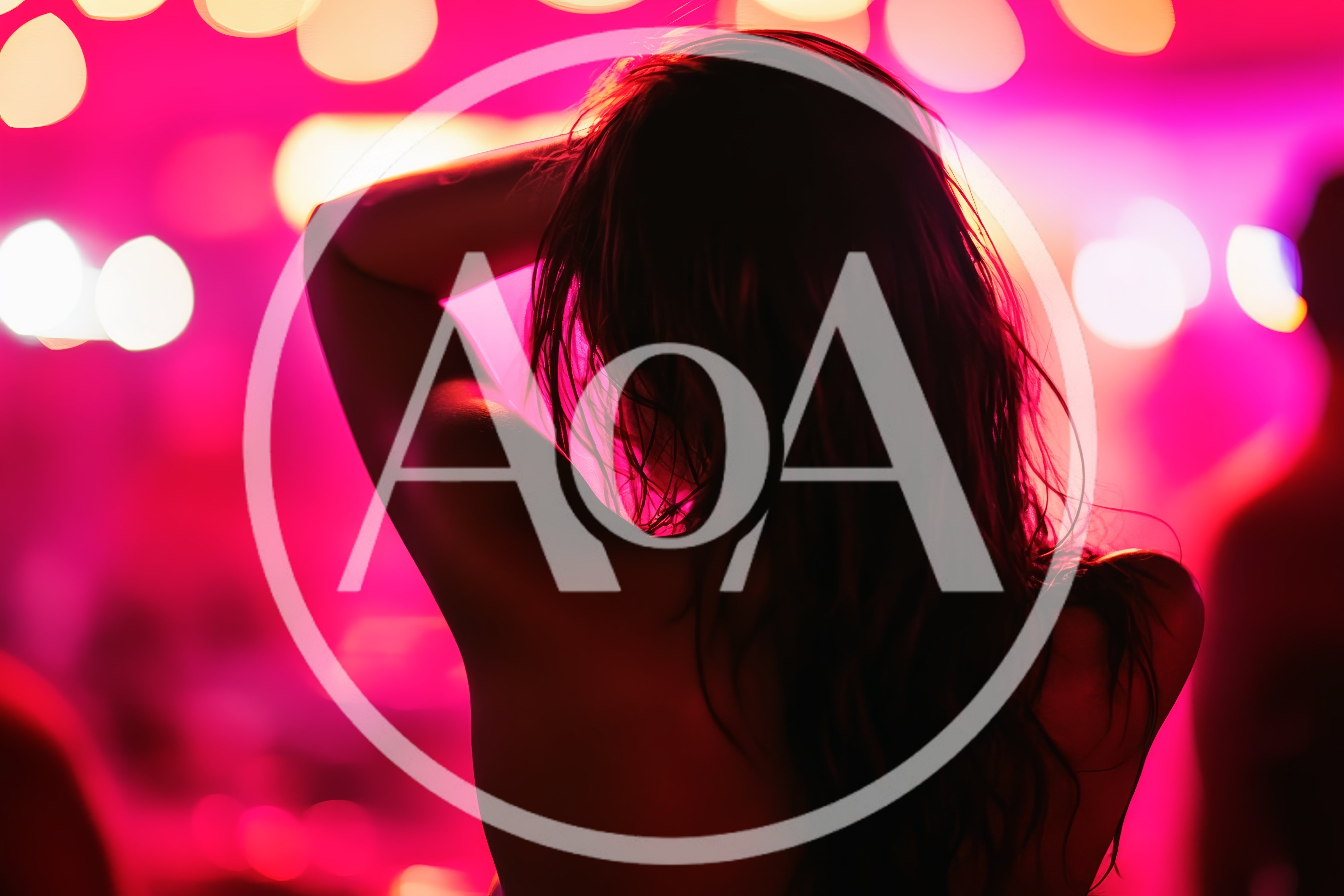 Woman Dancing With Arms Raised In Nightclub