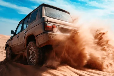 Off-Road SUV Driving Through Desert Sand Dunes