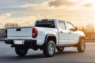 White Pickup Truck Parked Outdoors At Sunset
