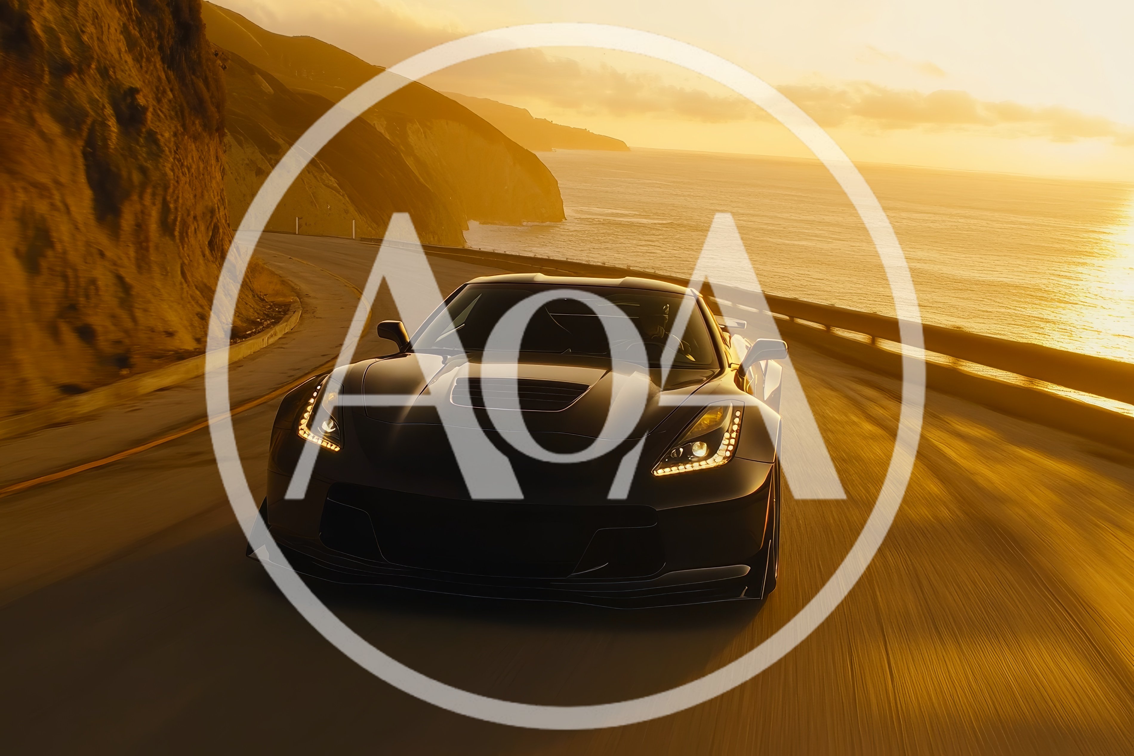Black Sports Car Driving Along Coastal Highway At Sunset