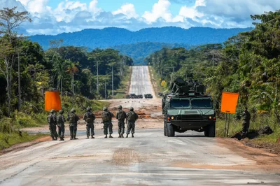 Military Soldiers Standing Guard Beside Armored Vehicle