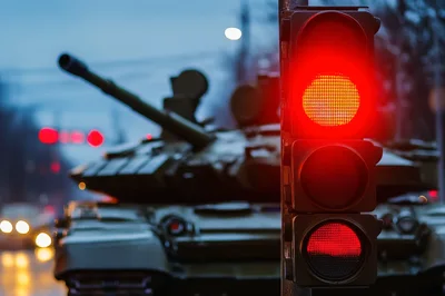Military Tank Stopped at a Red Traffic Light