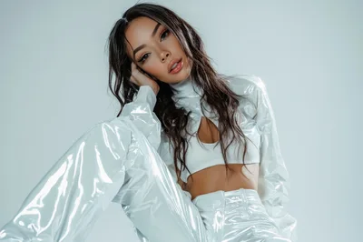 Fashion Model Posing In Shiny White Vinyl Outfit