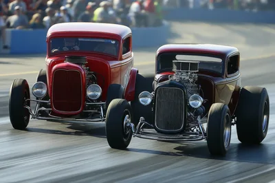Two Vintage Hot Rods Racing On Drag Strip