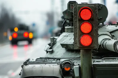 Military Tank Driving Past Traffic Light