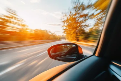 Car Side Mirror View During High Speed Highway Drive